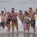 2018 Polar Bear Plunge participants standing in the surf