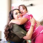 Woman hugs special needs student in school