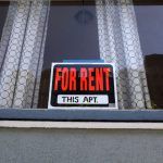 For Rent sign in apartment window