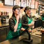 Employees take an order at Starbucks first U.S. signing store in D.C.