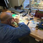 Jim Gardner repairs an old watch.