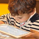 Toddler aged child with tablet device