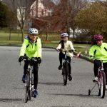 Lori Wells (from left) and her daughters Grace, 13, and Claire, 18, ride bikes in their Mullica Hill neighborhood during the coronavirus pandemic