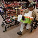 A shopper with disabilities navigates an isle at Northgate González Market on Tuesday, March 17, 2020, in Santa Ana, California.