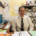 Counselor Joel Simon at his desk in his office at Cape Henlopen High School