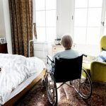 Elderly woman alone in wheelchair at long-term care facility