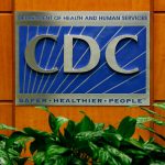 A sign of the CDC logo on the wall inside CDC headquarters