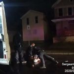 Footage from a police officer's body cam showing another officer pressing Daniel Prude to the ground