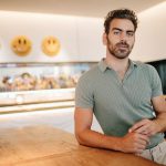 Reality TV star and Deaf activist Nyle DiMarco poses for a photo in his kitchen