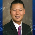 Charles Dhong is a medium-skinned man wearing a dark suit, white shirt and purple tie. A background graphic is blue with network illustration with glowing meeting points.