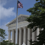 Exterior of the U.S. Supreme Court with flag.
