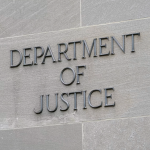 A sign marks the facade of the Robert F. Kennedy Department of Justice Building in Washington, D.C.