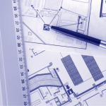 A pen and ruler lay on top of blueprints