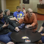 Otto Lewis (center) plays Uno with other students.
