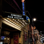 Pedestrians take photos of the marquee of the Egyptian Theatre before the Sundance Film Festival in Park City, Utah.