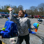 A child with medium-dark-toned skin plays with bubbles.