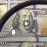 Video still of hundred dollar bills
