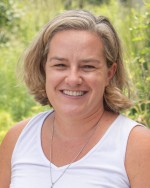 Headshot of Kara Baron. Kara is an adult female with short, blonde hair and is wearing a white shirt.